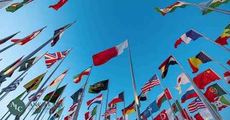 A vibrant display of national flags fluttering in the sky.